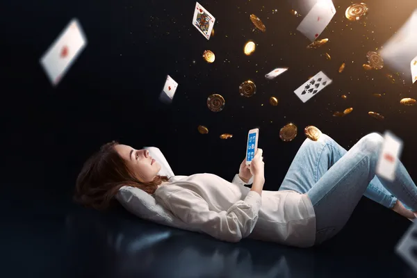 OKTA App — Enjoy seamless gaming on your smartphone A young woman relaxing with her phone while dynamic casino elements float around her, illustrating the smooth mobile experience offered by the OKTA app.