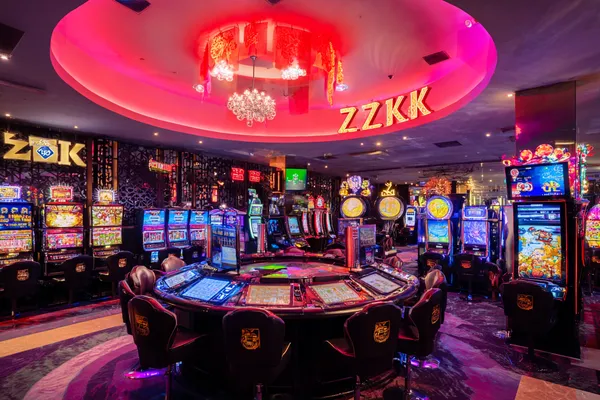 OKTA — A high-class gaming experience without limits A woman in a luxurious green gown next to an ornate roulette wheel, capturing the upscale casino mood of OKTA.