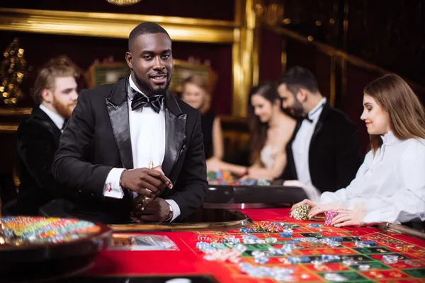 OKTA Jackpot Slots — Spin for massive rewards A dramatic shot of winning sevens landing on a slot reel surrounded by shining gold coins, symbolizing big wins.